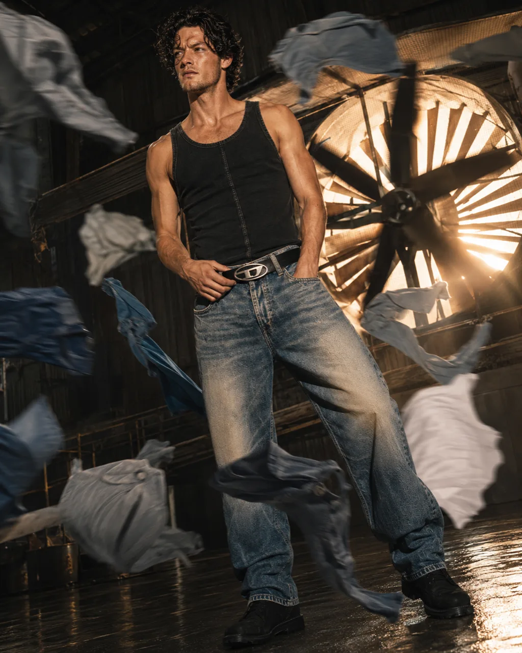 Model in front of an industrial fan with fabric flying