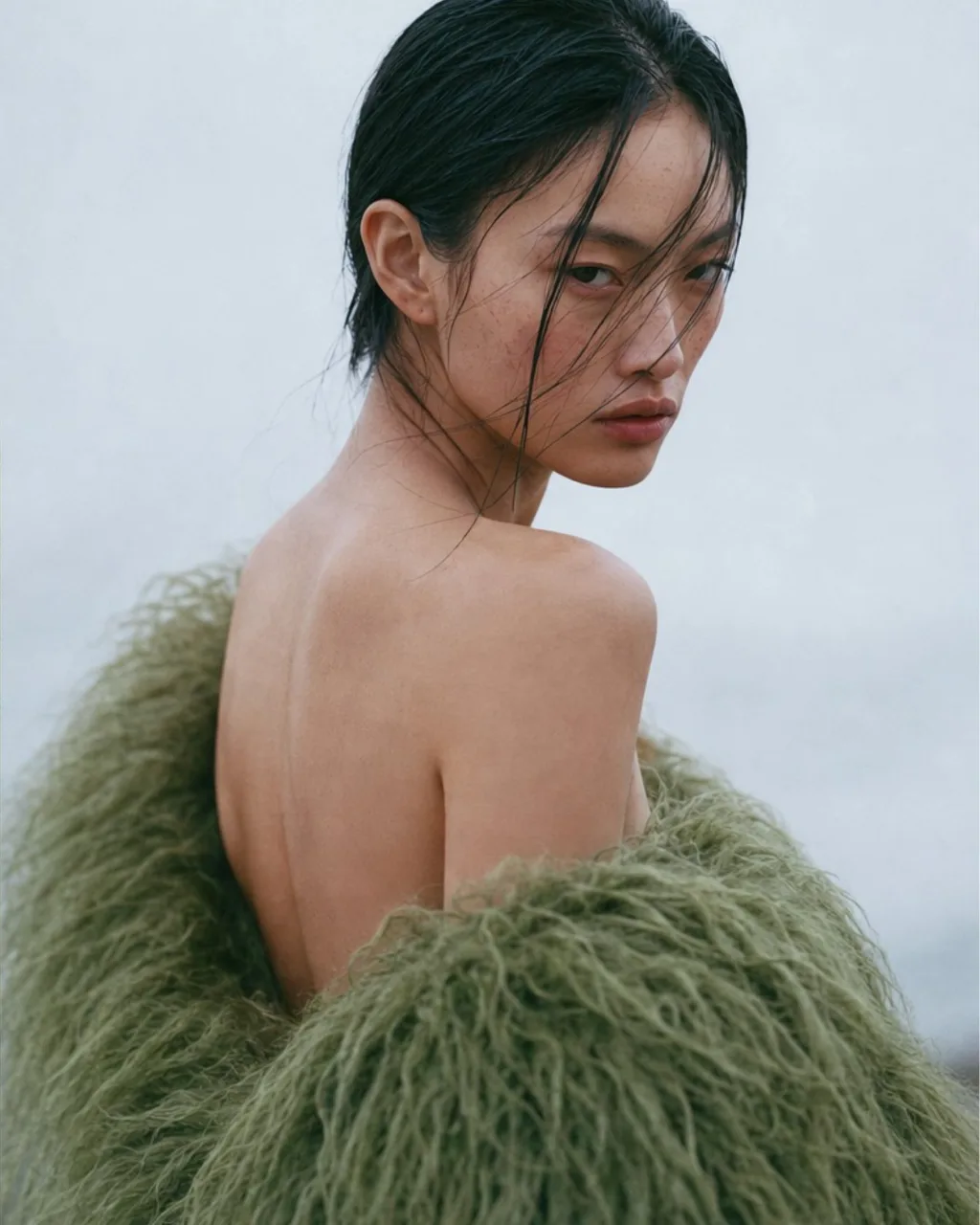 Bare shoulder and the shearling, looking back