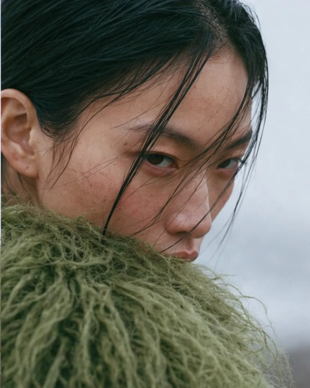 Close crop, wet hair across the face