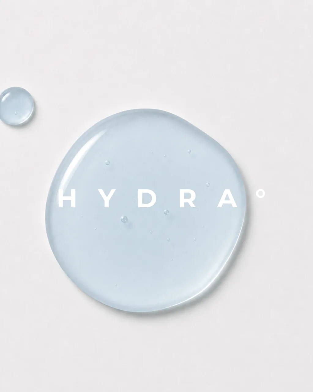 HYDRA key visual: a pool of clear pale blue serum seen from above, a smaller droplet beside it, with the HYDRA name across it