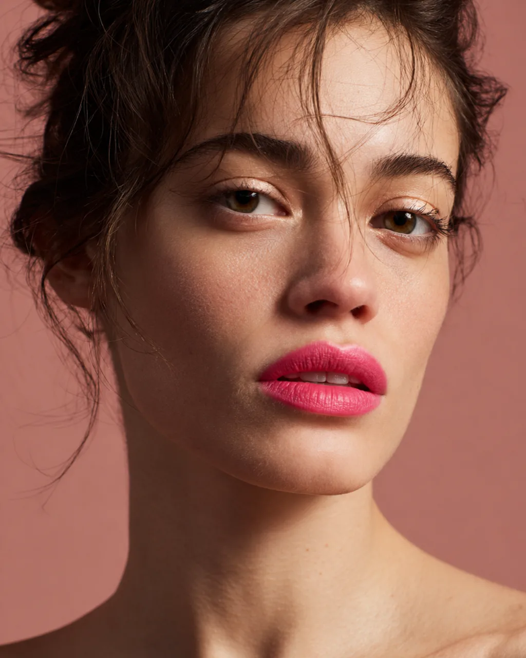 MUSE lipstick: a close portrait of a dark-haired model in bright pink lipstick against a dusty pink backdrop, AI concept work