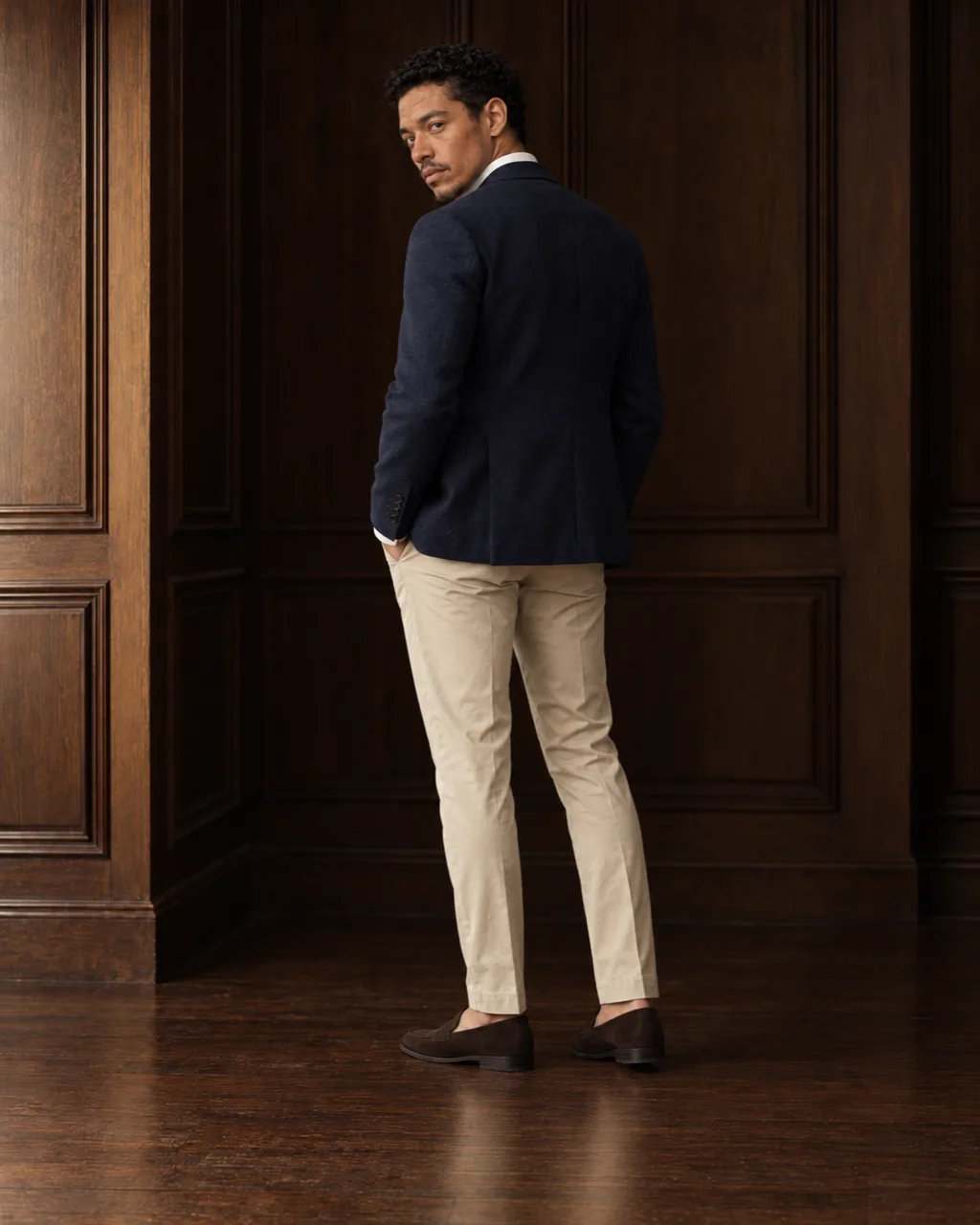 Sunderly look 4, navy blazer, white shirt and stone chinos: from behind, three-quarter view, AI concept work