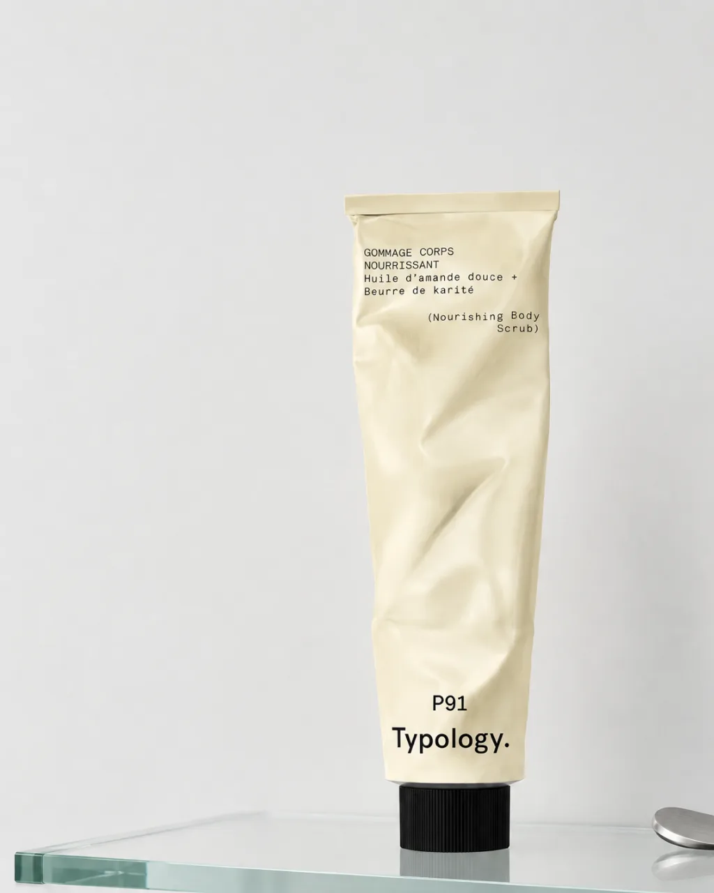Typology concept: a P91 body scrub tube on a glass shelf against a pale wall