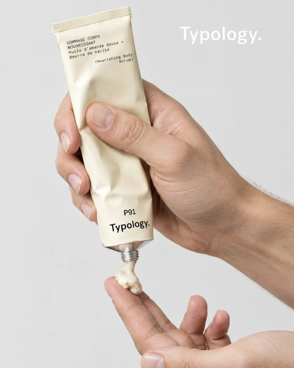 Typology P91 body scrub squeezed onto a fingertip, Typology wordmark top right, AI concept work